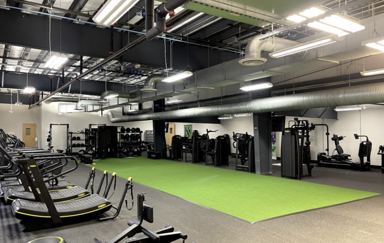 Performance and strength training facility with turf strip and equipment